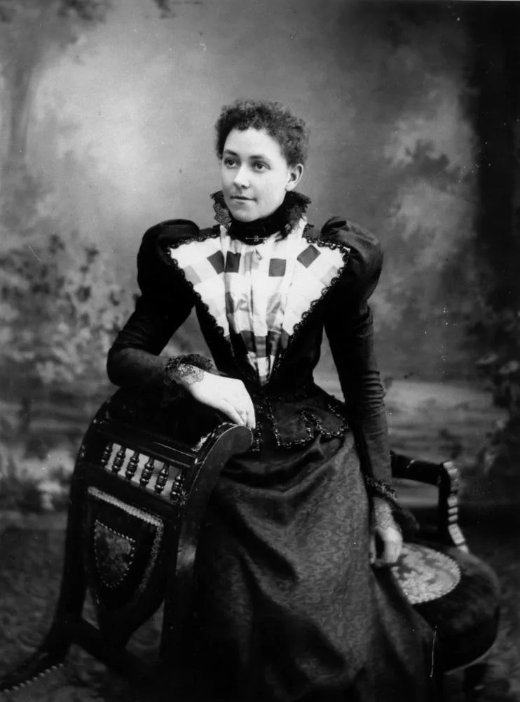 StateLibQld 1 99972 Woman in a distinctive outfit, posing for a studio portrait , 1890-1900