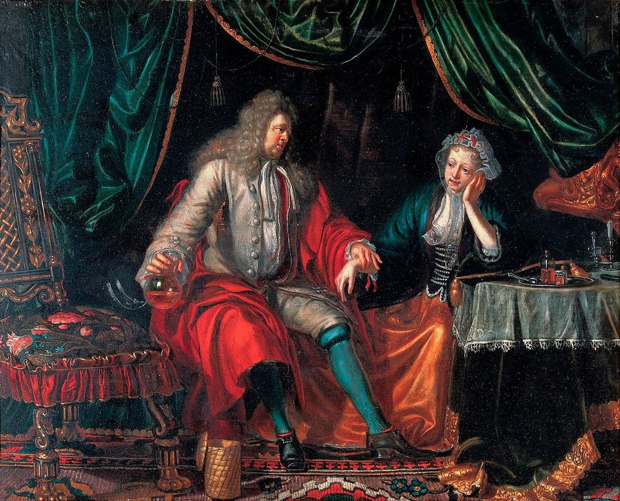 A physician feeling the pulse of a seated woman patient.